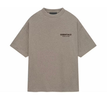 A light brown heathered short-sleeve t-shirt with 'ESSENTIALS FEAR OF GOD' printed in black on the left chest, displayed on a solid white background.